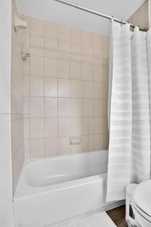 a bathroom with a shower and a bath tub
