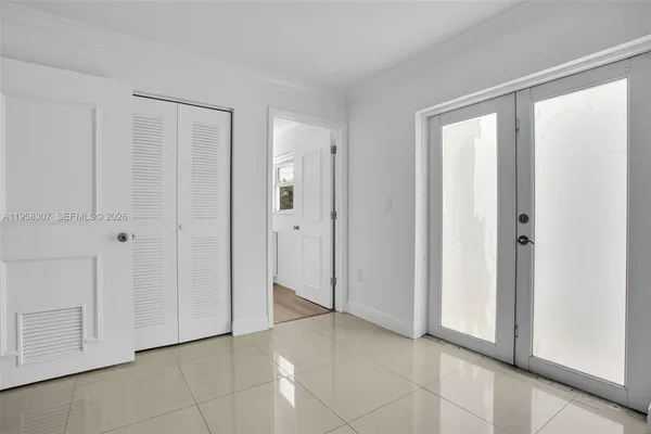 a view of an empty room with closet area