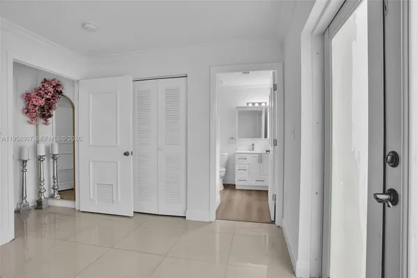 a view of a hallway with closet and bathroom