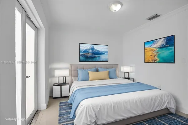 a bedroom with a bed and a painting on the wall