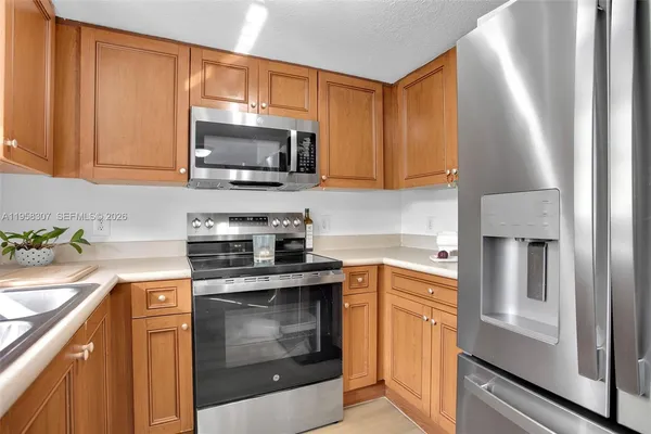 a kitchen with stainless steel appliances granite countertop a stove microwave and sink