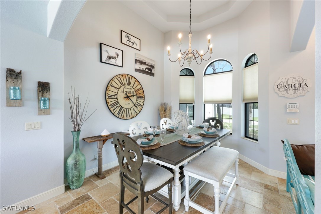 208 Southwest 15th Street Cape Coral, FL 33991 - Photo 12 of 50 a view of a dining room with furniture a chandelier and wooden floor