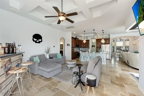 a living room with furniture a rug and a floor to ceiling window