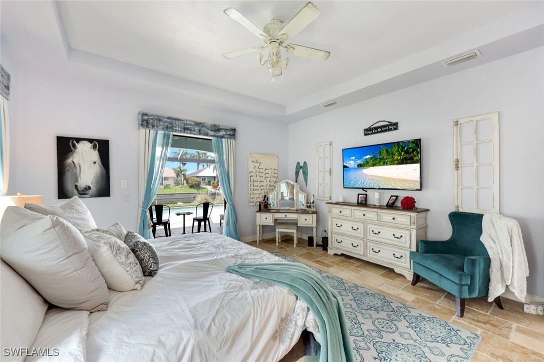 208 Southwest 15th Street Cape Coral, FL 33991 - Photo 16 of 50 a bedroom with a bed and a flat screen tv