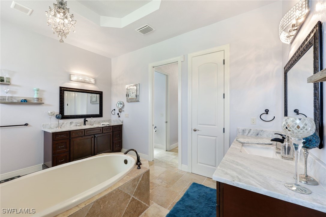 208 Southwest 15th Street Cape Coral, FL 33991 - Photo 18 of 50 a bathroom with a tub sink and mirror
