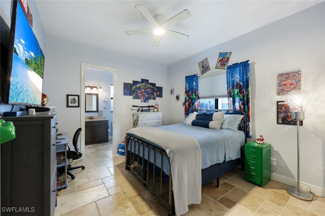 208 Southwest 15th Street Cape Coral, FL 33991 - Photo 19 of 50 a bedroom with a bed and a chandelier