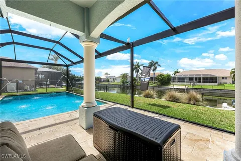 a view of a patio with a table chairs and a backyard
