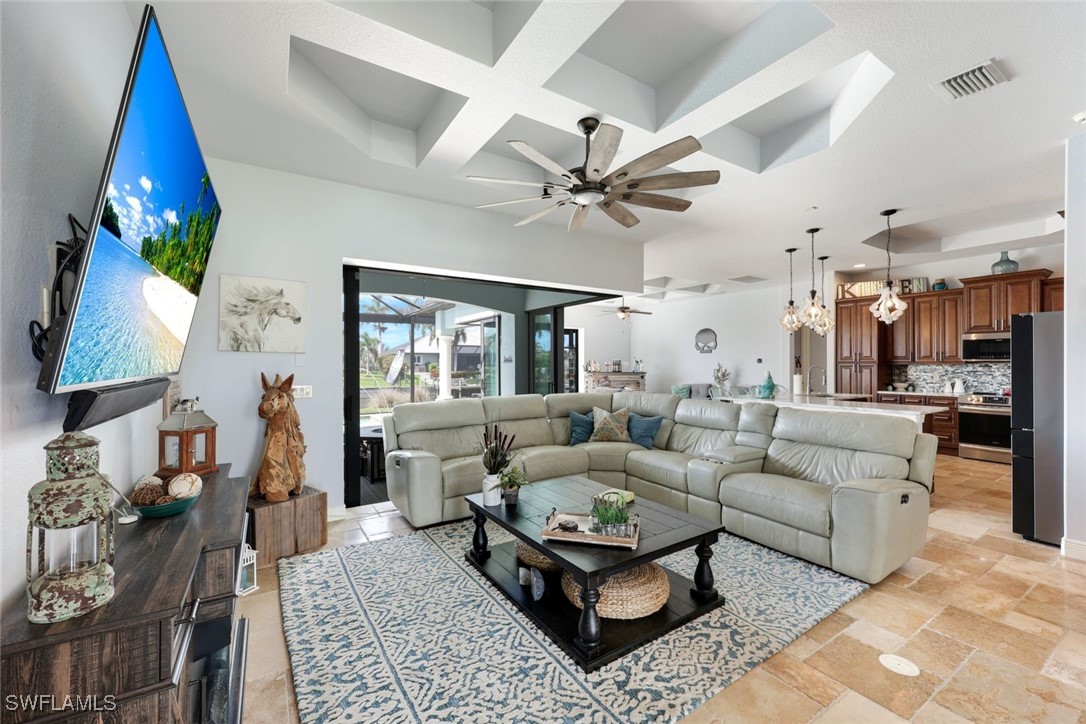 208 Southwest 15th Street Cape Coral, FL 33991 - Photo 6 of 50 a living room with furniture and a chandelier