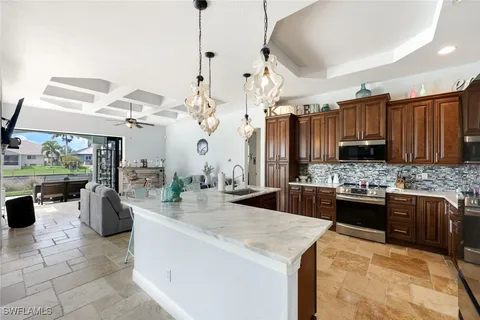 a kitchen with stainless steel appliances kitchen island granite countertop a sink and cabinets