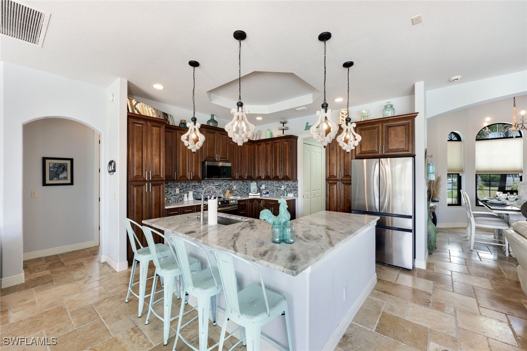208 Southwest 15th Street Cape Coral, FL 33991 - Photo 10 of 50 a view of a dining room with furniture and chandelier