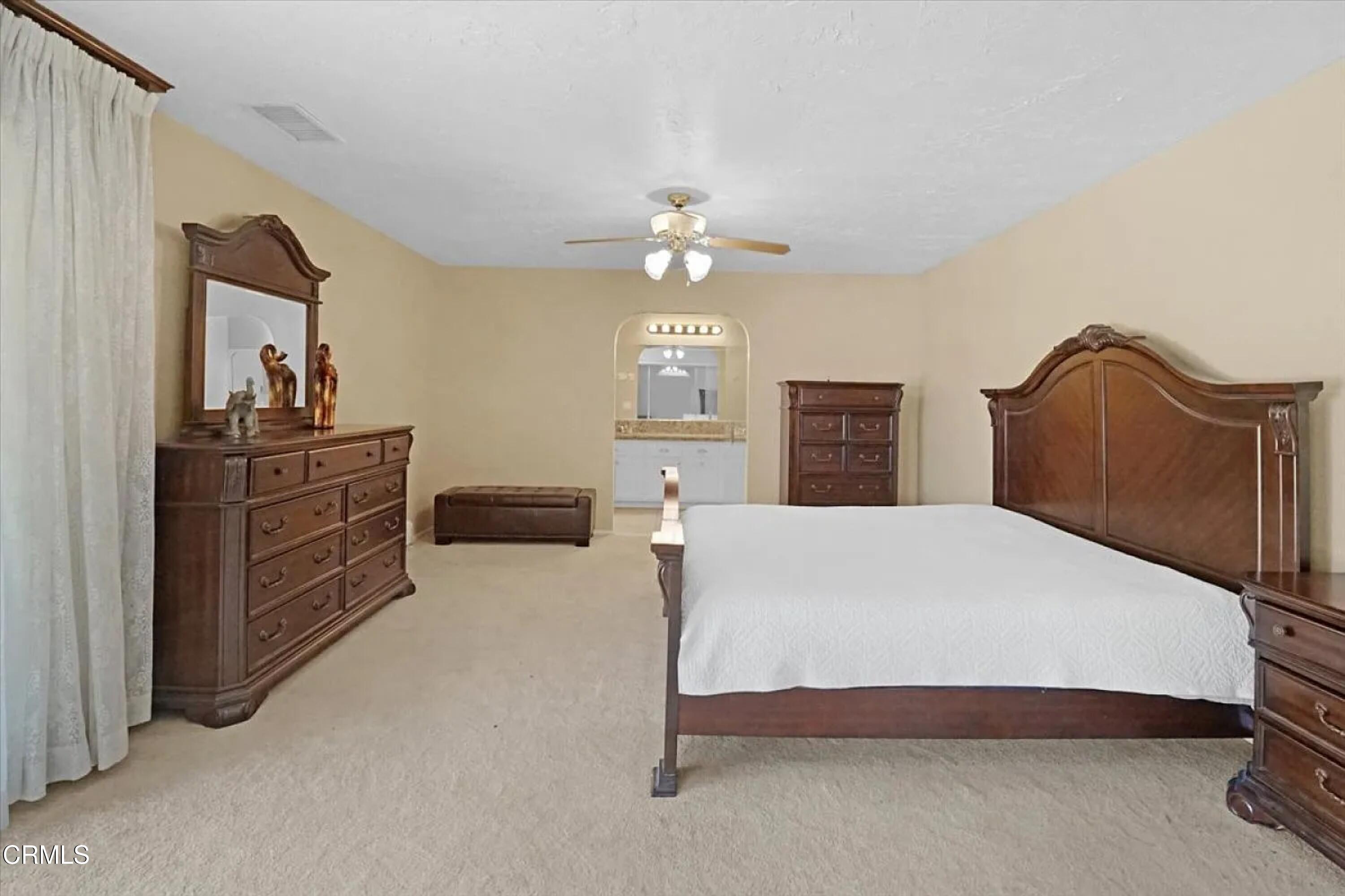 14027 Chogan Road Apple Valley, CA 92307 - Photo 14 of 33 a bedroom with a bed and dresser