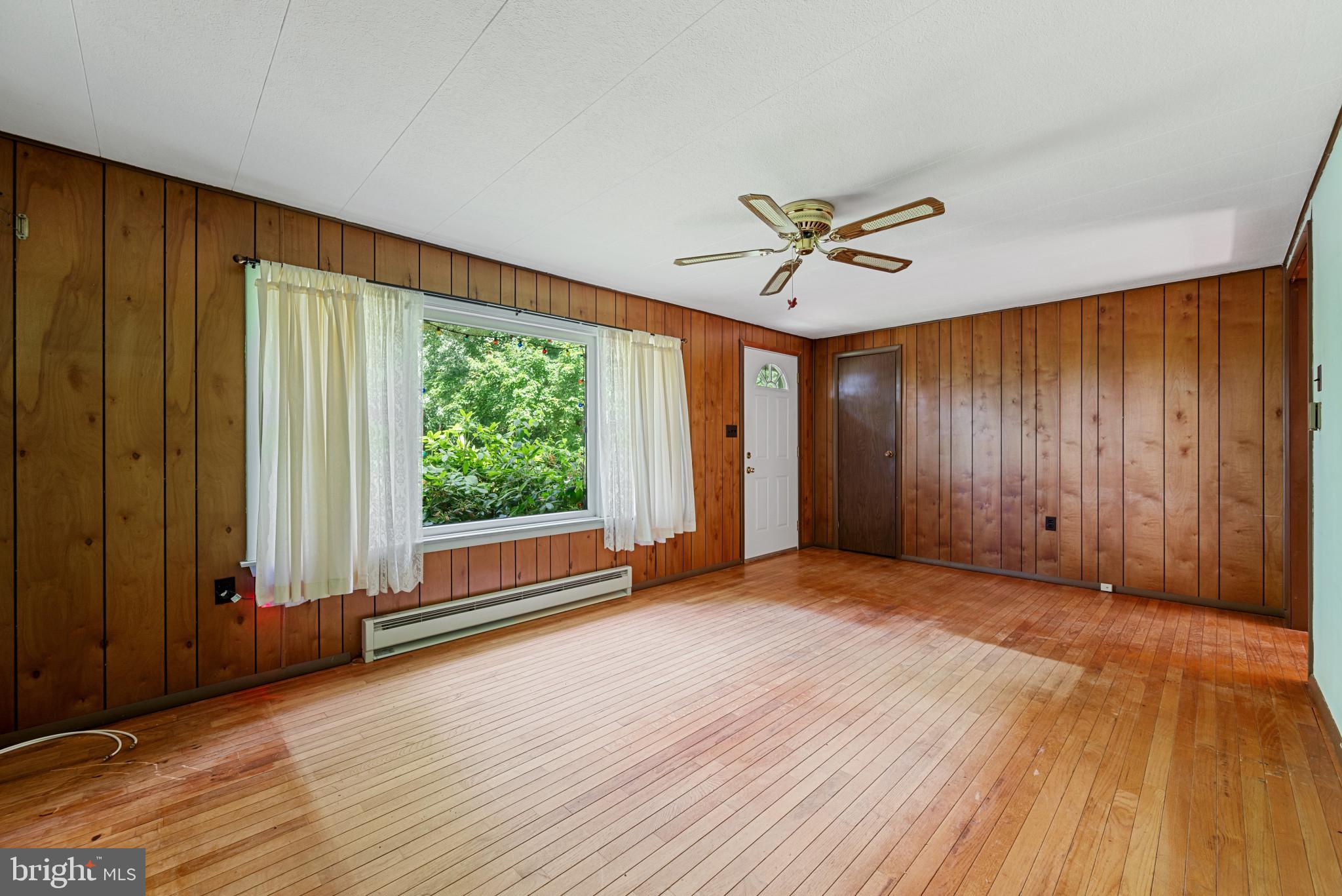 21008 West Liberty Road White Hall, MD 21161 - Photo 3 of 16 Sunlit main living area has hardwood floors
