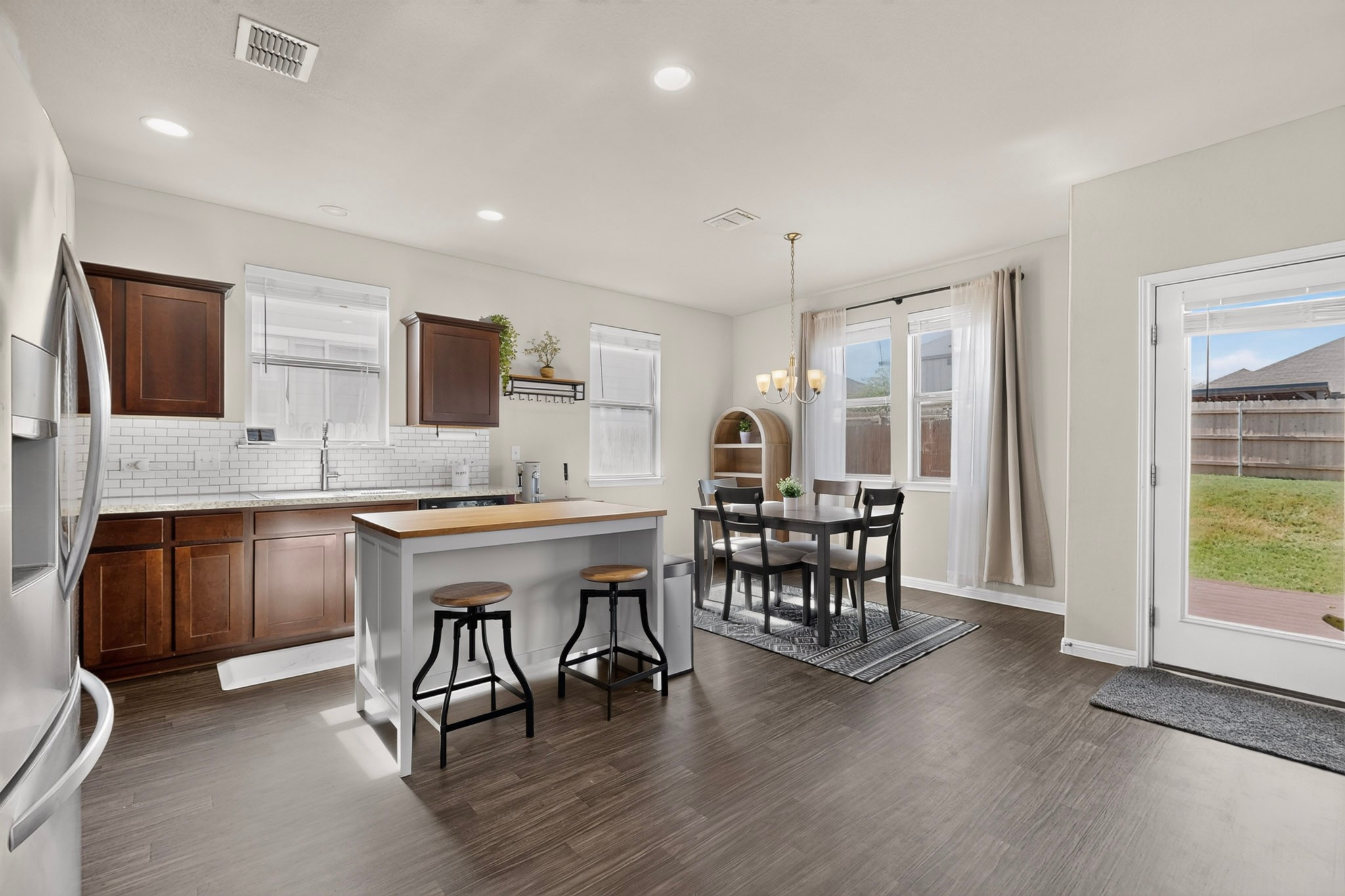 132 Wapiti Road Buda, TX 78610 - Photo 5 of 31 A well-appointed kitchen and dining area provides direct access to the backyard, ideal for effortless indoor-outdoor living.