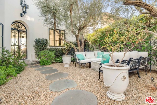 a view of a patio with table and chairs and potted plants