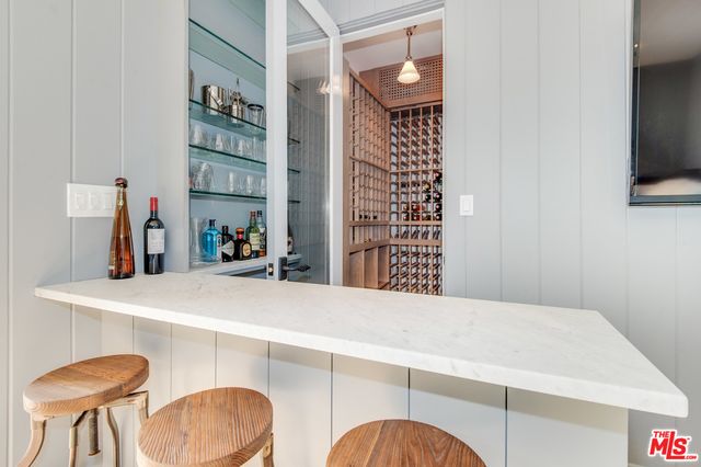 a room with a table chairs and a refrigerator