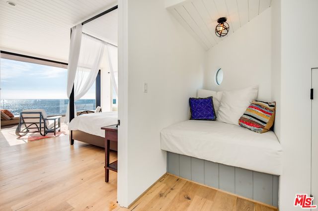 a bedroom with furniture and a wooden floor