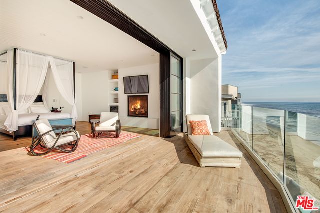 a bedroom with furniture and a large window