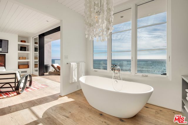 a white tub sitting next to a window