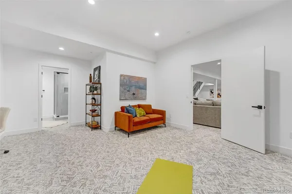 a spacious bedroom with a bed and a couch