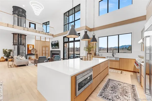 a large white kitchen with a large window