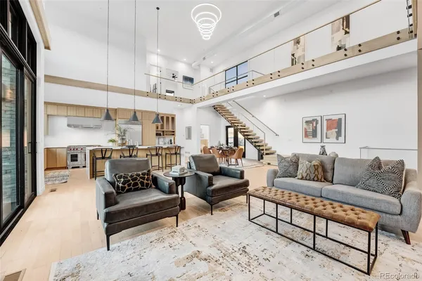 a living room with furniture and a chandelier