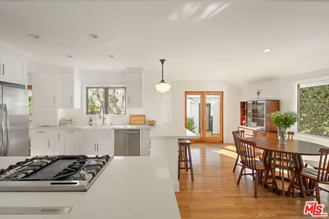 a kitchen with sink stove and refrigerator