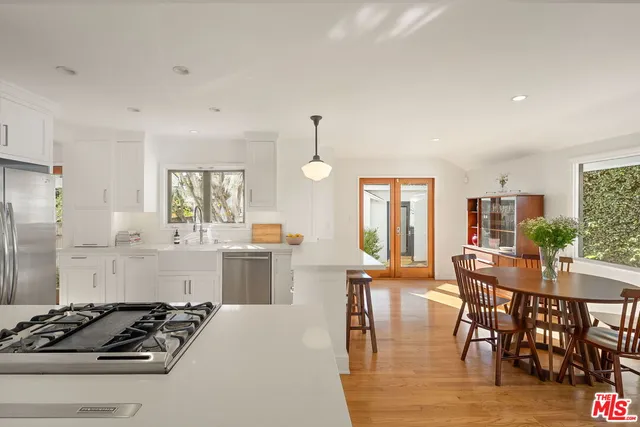 a kitchen with sink stove and refrigerator