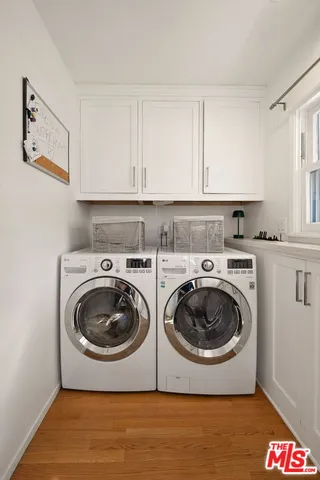 a utility room with sink dryer and washer
