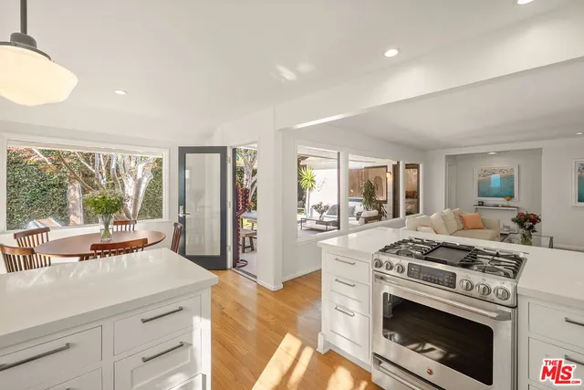 a kitchen with a stove a sink and a refrigerator