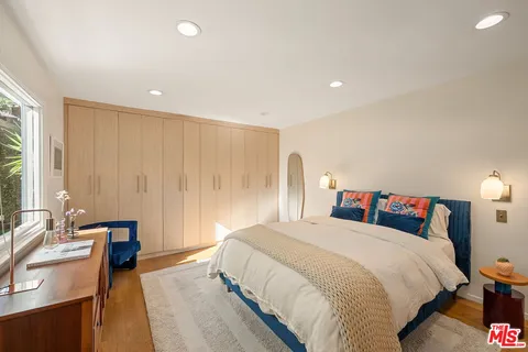 a bedroom with a bed and a couch