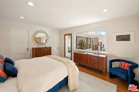 a bedroom with a bed and a dresser