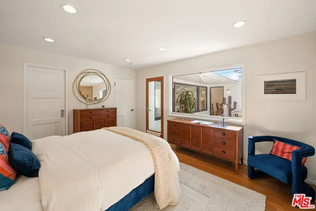 a bedroom with a bed and a dresser