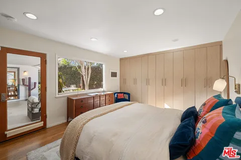 a bedroom with a large bed and a window