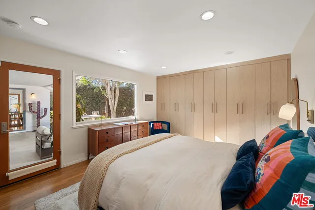 a bedroom with a large bed and a window