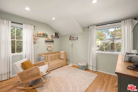 a bedroom with furniture and a window
