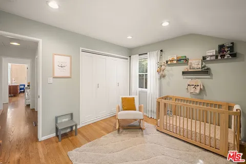 a bedroom with furniture and wooden floor