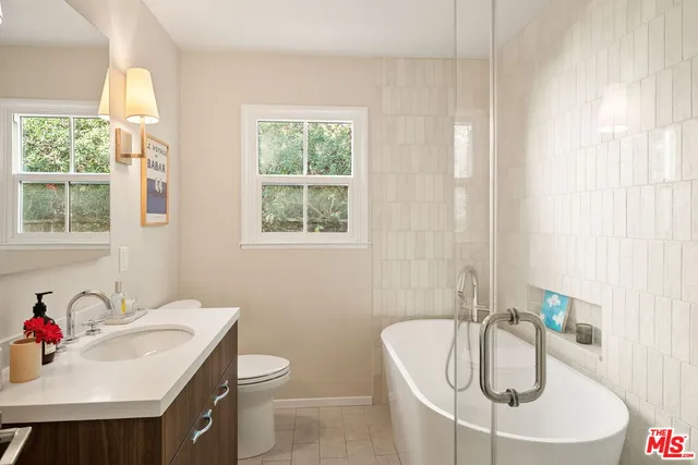 a bathroom with a sink a toilet and a tub