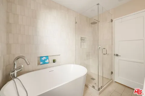 a bathroom with a tub and shower