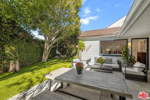 a view of yard from deck with patio