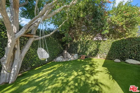 a view of a chair and table in the garden