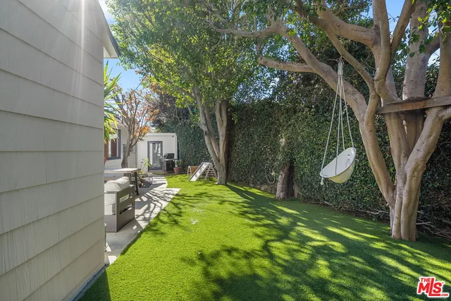 a backyard of a house with table and chairs