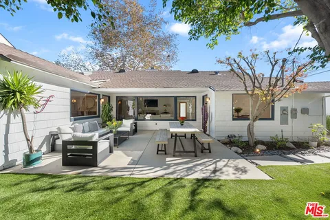 a view of a house with backyard porch and sitting area