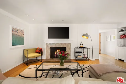 a living room with fireplace furniture and a flat screen tv