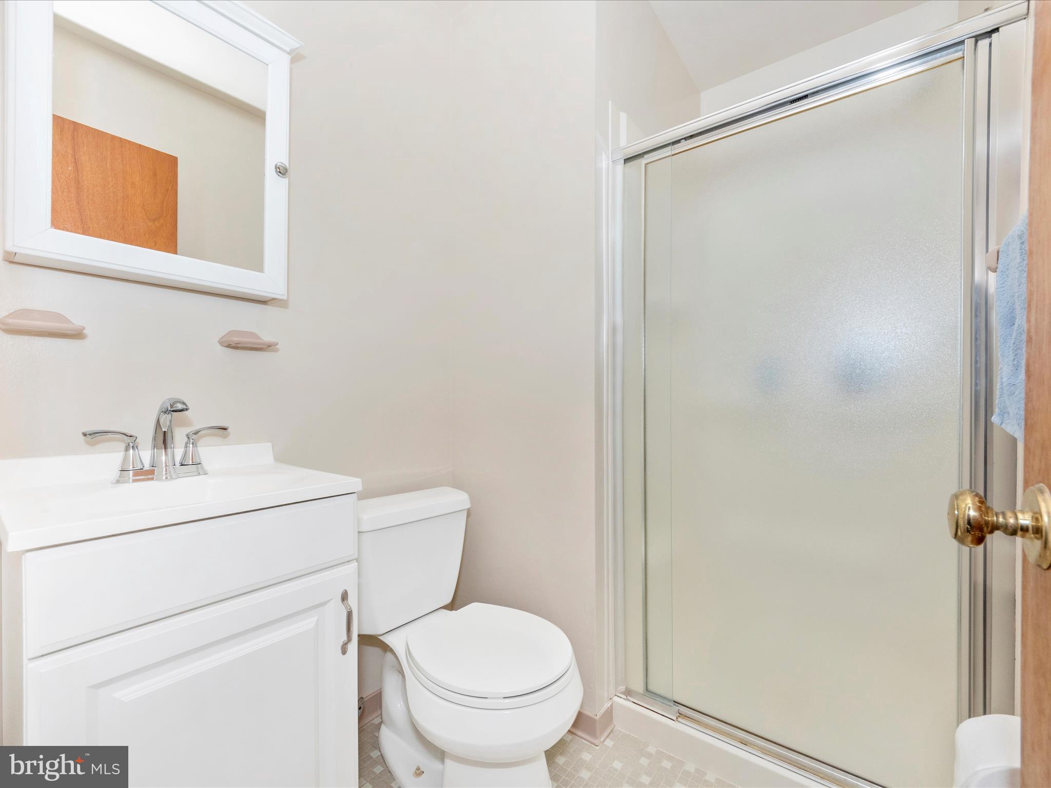 3180 Hunting Creek Road Huntingtown, MD 20639 - Photo 28 of 55 a bathroom with a toilet sink vanity and mirror