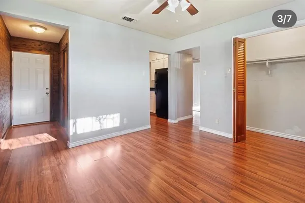 a view of a hallway with wooden floor