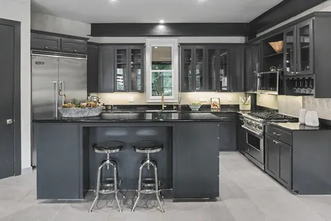 a kitchen with stainless steel appliances granite countertop a stove and a sink