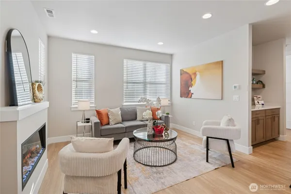 a living room with fireplace furniture and a wooden floor