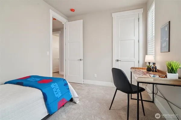 a bedroom with a bed and a table in it