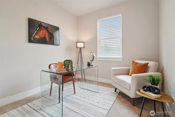 a living room with furniture a rug and a window