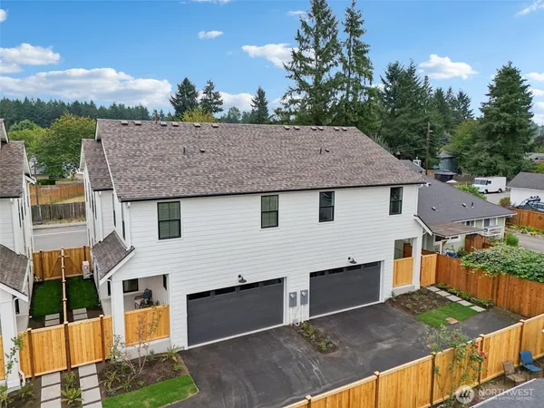 an aerial view of a house with a mountain